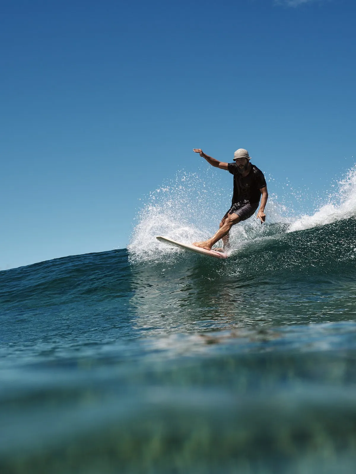Jay Sueno performing a top turn on a clean wave at Rock Island, Siargao. Vultun Surf founder coaching