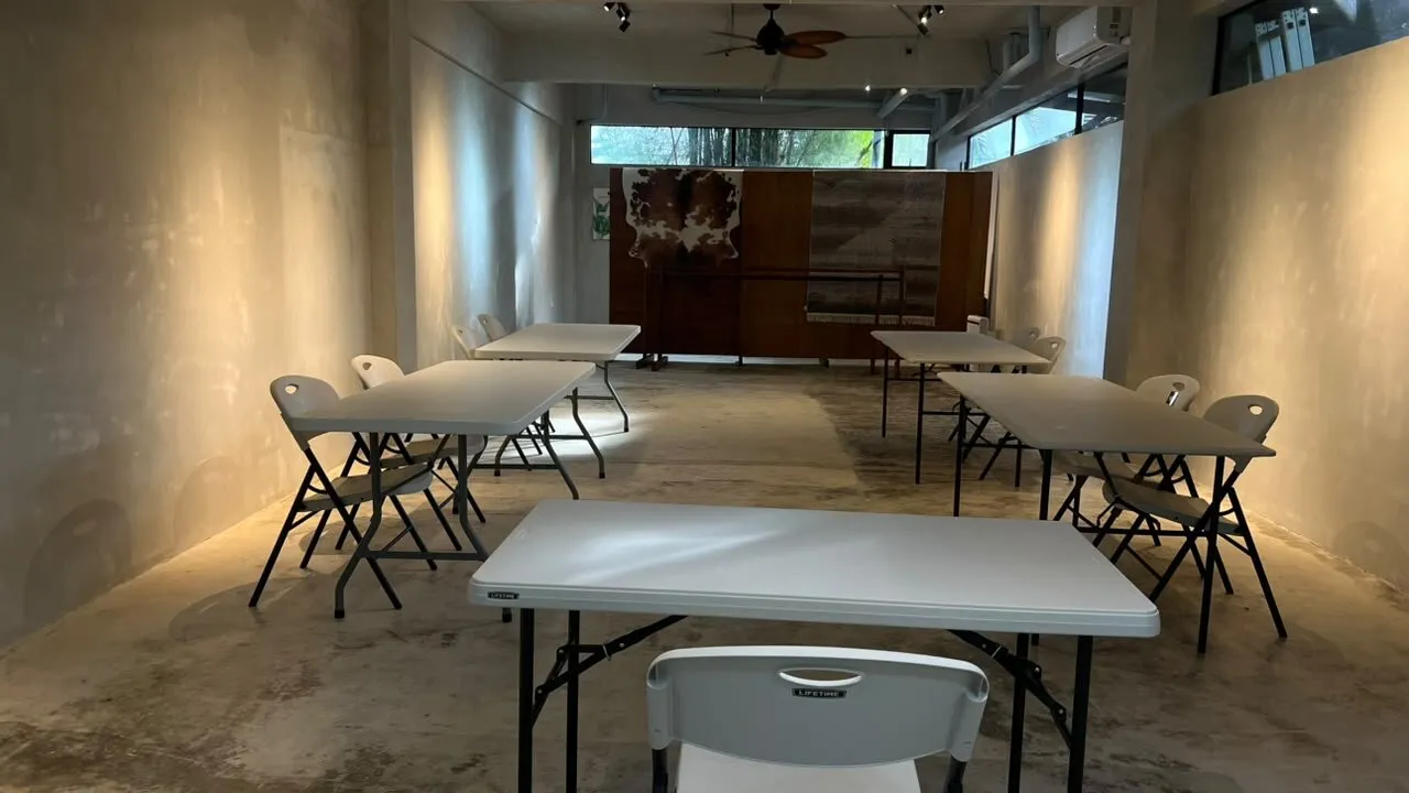 Holding Space set up with tables and chairs for a seminar