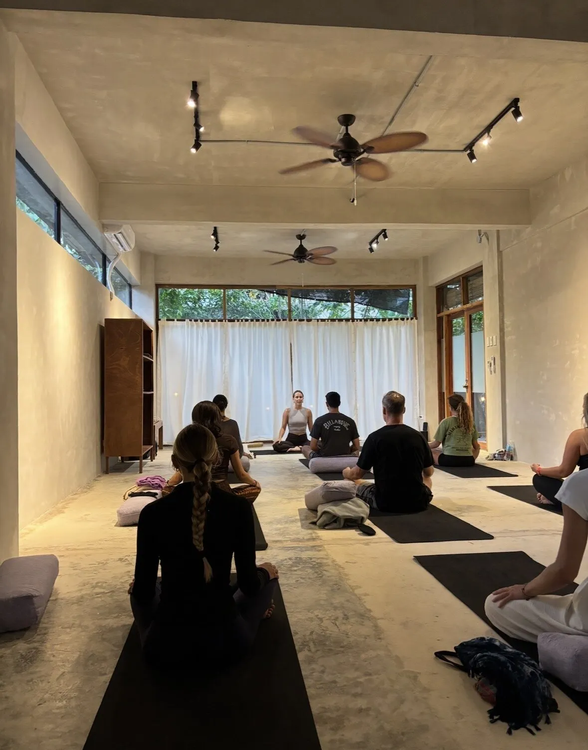 Teacher leading a seated group session at Holding Space
