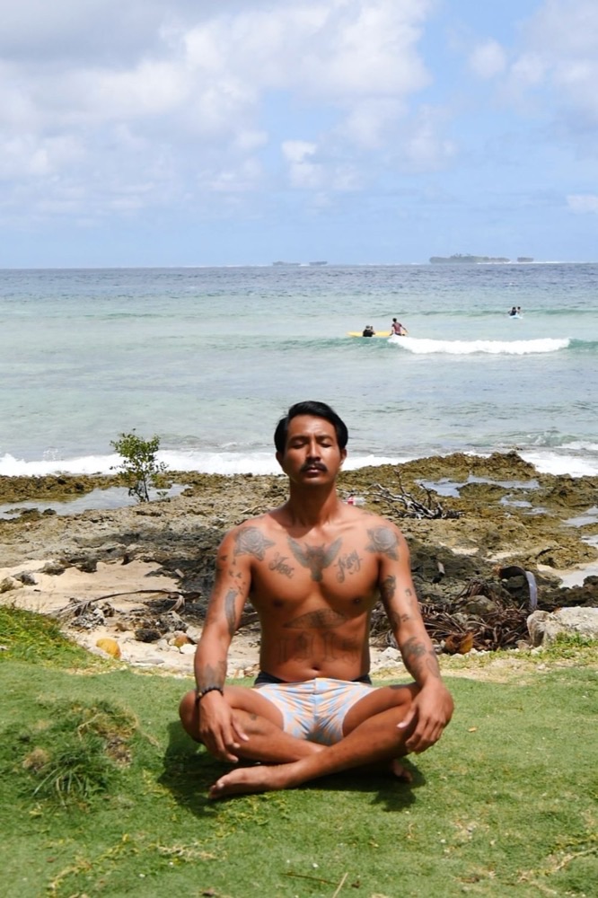 Man meditating at Jacking Horse Beach, Siargao